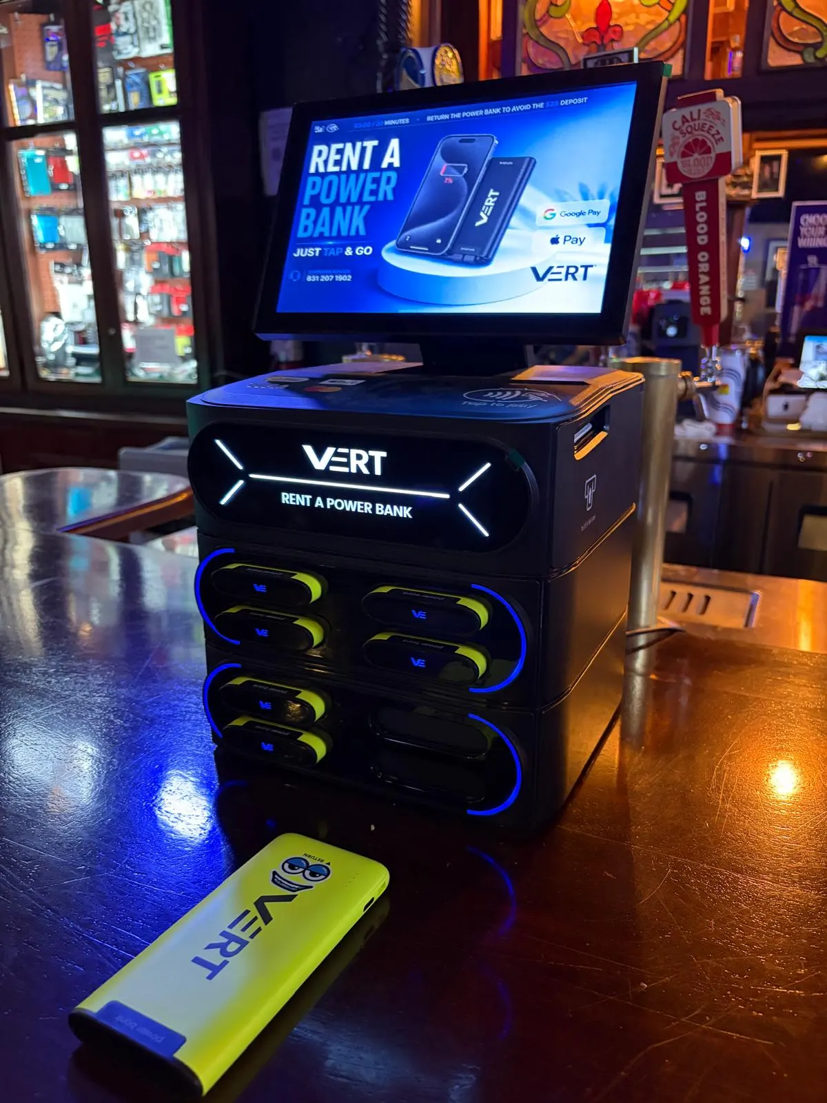 VERT station and a yellow powerbank on a bar at night