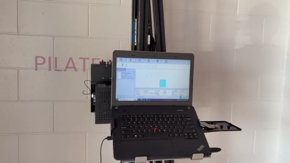 The printer control laptop in front of a studio wall