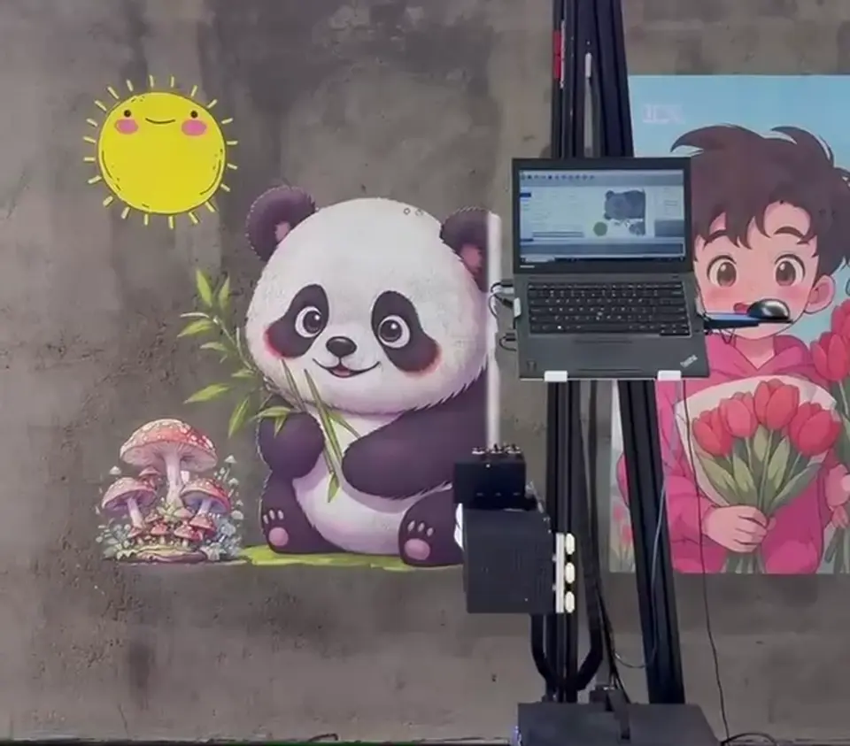 The wall printer beside a colourful panda mural it is printing