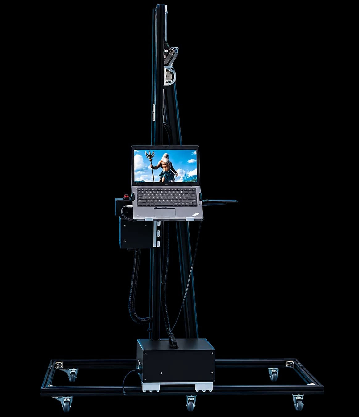 Front view of the VERT wall printer: vertical mast, print carriage, control laptop, base unit and floor rail on casters.